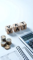 VAT tax concept with wooden letter blocks, euro coins, calculator and financial documents on white background for accounting and business taxation.