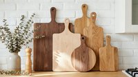 Wooden cutting boards of various sizes and shapes arranged on a kitchen counter with white brick wall, natural light, rustic home decor.