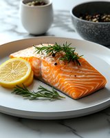 Grilled salmon fillet with fresh rosemary herbs and lemon slice on white plate, healthy seafood dinner meal ready to serve for restaurant menu.