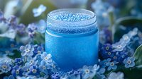 Magical blue jar with glitter rim surrounded by delicate forget-me-not flowers in soft focus, creating dreamy atmospheric composition for wellness and spa designs.