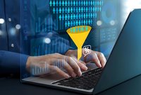 Business professional analyzing data with digital funnel visualization and analytics dashboard on laptop for marketing strategy optimization.