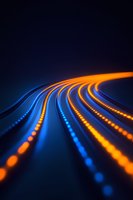 Curved lines of glowing orange and blue light trails creating dynamic parallel paths against dark background, abstract technology concept for digital connectivity.