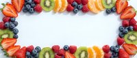 Fresh colorful fruit border frame with strawberries, blueberries, kiwi, raspberries, and orange slices on white background, isolated for design use.