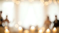 Warm bokeh lights background with blurred kitchen utensils and candles creating cozy atmospheric lighting for culinary and home decor projects.