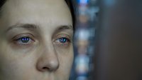Young adult woman with fair complexion, blue eyes, and light brown hair displaying a neutral expression, suitable for healthcare, wellness, and emotional content.