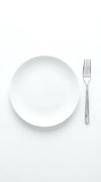Empty white plate with silver fork on white background, isolated and ready for food styling, restaurant menu design, and culinary content creation.
