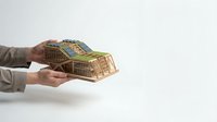 Hands holding cardboard delivery boxes with shipping labels on white background for e-commerce and logistics concepts.