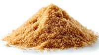 Heap of unrefined brown sugar crystals isolated on white background, perfect for baking, cooking, and food photography.