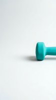 Single turquoise dumbbell isolated on white background, ready for fitness and wellness design projects, marketing materials, and health-related content.