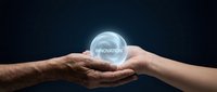 Two hands holding glowing sphere with innovation text representing teamwork, collaboration and creative business solutions on dark background.