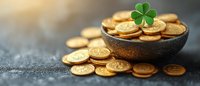 Golden coins in rustic bowl with green shamrock clover leaf on dark background, St Patrick's Day celebration concept for holiday greeting cards.