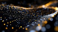 Glowing golden particles forming wave pattern on dark background with bokeh light effect and depth of field, digital network visualization.
