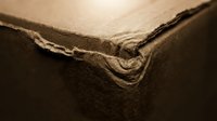 Close-up of aged brown leather corner showing natural wear and texture details for craftsmanship and material design projects.