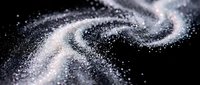 Swirling white powder or dust particles flowing in dynamic motion against a dark background, creating an ethereal, flowing effect for design and visual effects projects.