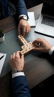 Business professionals arranging wooden cubes with arrows on a desk, symbolizing strategy, teamwork, and corporate growth direction.