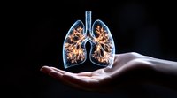 Glowing holographic lungs floating above open palm against dark background, depicting respiratory system visualization for medical and healthcare concepts.