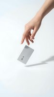 Hand reaching for white credit card with chip on clean white background for financial and payment concepts.