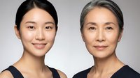 Two Asian women of different generations showcasing natural aging process and skincare journey from young adult to mature woman against neutral background.