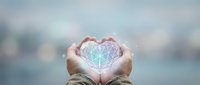 Hands cupping glowing geometric heart with sacred geometry pattern against soft bokeh background symbolizing love, protection and spiritual connection.