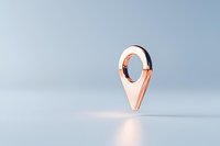 Metallic rose gold location pin icon floating on light blue background, casting subtle shadow on reflective surface.
