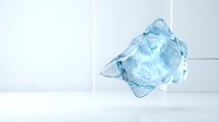Transparent ice cube with sharp crystalline edges suspended in mid-air against white background, isolated for design and advertising use.