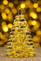 Golden glass ornament Christmas tree with warm bokeh lights background creating festive holiday atmosphere for seasonal decorations and celebrations.