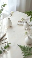 Minimalist white ceramic vases with spring cherry blossoms and green fern leaves on neutral linen table setting for home decor and botanical styling.