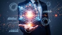 Businessman holding glowing hexagonal hologram with network connections and data visualization elements representing digital transformation and innovation.