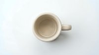 Empty ceramic mug with handle isolated on white background, ready for beverage mockup designs, branding, and product presentations.