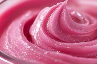 Pink creamy swirl texture with glossy finish for cosmetic skincare beauty product backgrounds and luxury spa wellness design applications.
