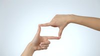 Hands forming frame gesture on white background, fingers creating rectangular shape for photography composition and creative vision concept.
