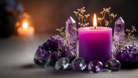 Purple candle surrounded by amethyst crystals and dried flowers creating mystical spiritual atmosphere for meditation and healing rituals.