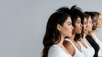 Diverse group of women standing in profile showing different ethnicities and ages representing unity, diversity and female empowerment in modern society.