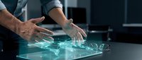 Male professional with light skin tone wearing business casual attire interacting with holographic digital interface on glass surface, representing technology innovation and futuristic business solutions.