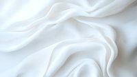 Elegant white silk fabric with soft waves and gentle folds creating subtle shadows and highlights on pure textile surface. Luxury background for wedding designs.