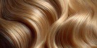 Luxurious blonde hair with golden highlights flowing in smooth waves, showcasing healthy shine and silky texture for beauty and haircare concepts.