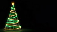 Glowing Christmas tree with golden star and spiral lights on dark background for holiday greeting cards and festive decorations.