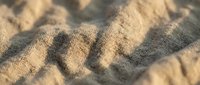 Close-up of woven fabric texture with natural beige and gray tones, showing detailed weave pattern and thread structure for textile design and material backgrounds.