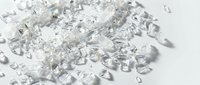 Scattered transparent glass shards and crushed ice fragments on white surface, suitable for luxury, fragmentation, and abstract design projects.