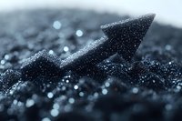Glittering black crystal arrow formation with sparkles against dark background, macro photography showing detailed mineral structure and light reflections.