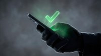 Hand holding smartphone displaying glowing green checkmark symbol, representing approval, success, confirmation and digital validation for mobile app, web design and technology concepts.