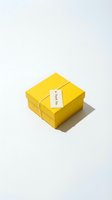 Yellow gift box with a thank you tag tied with twine, isolated on white background for greeting, celebration, and retail concepts.