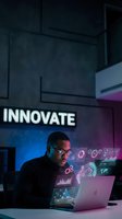 African American businessman working on laptop with holographic data displays and innovate text in modern office environment for technology presentations.