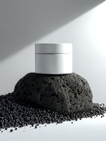 White cosmetic jar on volcanic stone surrounded by black caviar pearls against light gray background with dramatic shadow for luxury skincare product presentation.