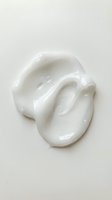 White cosmetic cream or moisturizer smear isolated on light background, suitable for skincare product packaging, beauty advertising, and cosmetic design projects.