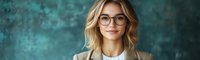 Young professional woman with blonde wavy hair and glasses wearing beige blazer and white top smiling confidently against textured turquoise wall background.