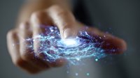 Mystical glowing galaxy spiral floating above open palm with ethereal blue and purple energy swirls, magical light effects and particles creating cosmic atmosphere.