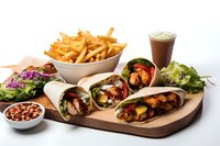Delicious chicken wrap platter with french fries, fresh salad and chocolate milkshake served on wooden board. Perfect for restaurant menu, food delivery or cafe advertising.
