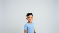 Young boy with dark hair and olive complexion wearing light blue t-shirt, standing against neutral white background, suitable for family, parenting, childhood, and educational design projects.
