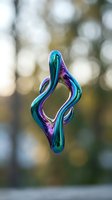 Iridescent liquid metal form with flowing curves in vibrant blue, purple, and teal tones against soft blurred bokeh background. Contemporary abstract art.